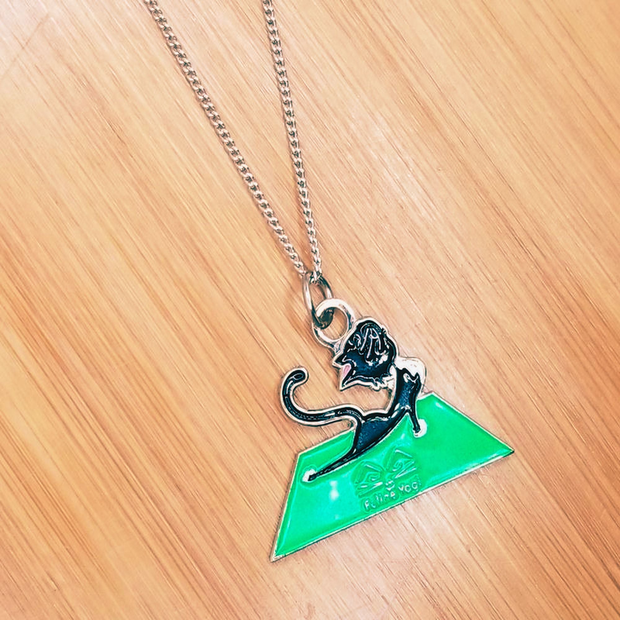black cat on green mat necklace